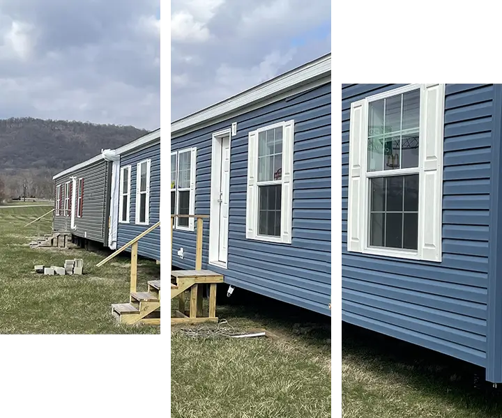 Blue mobile home with white-framed windows.